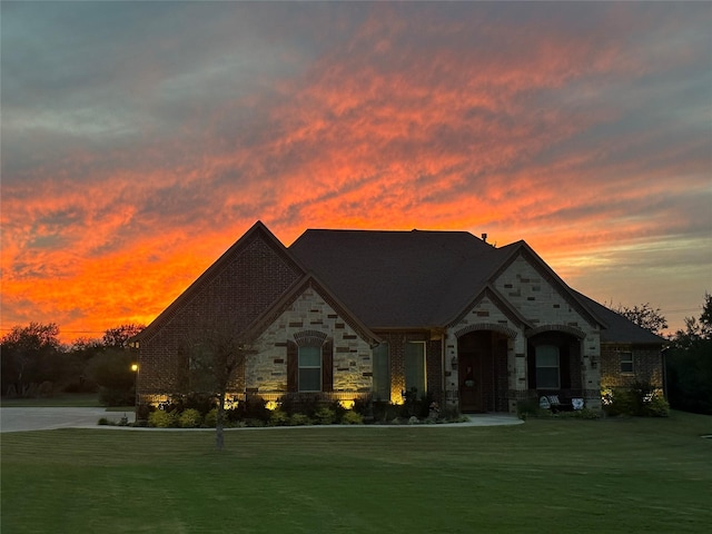 french country style house featuring a lawn