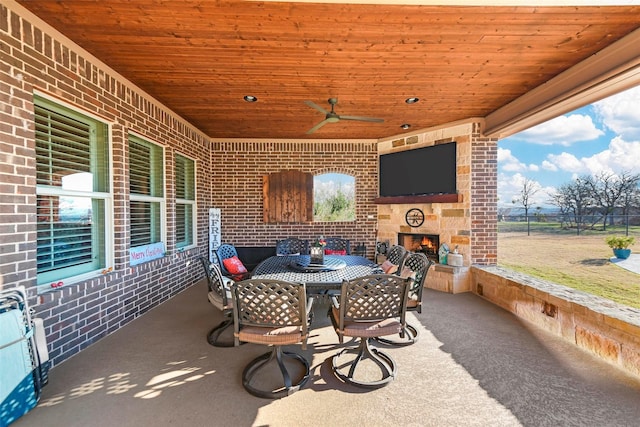 view of patio / terrace with an outdoor stone fireplace and ceiling fan