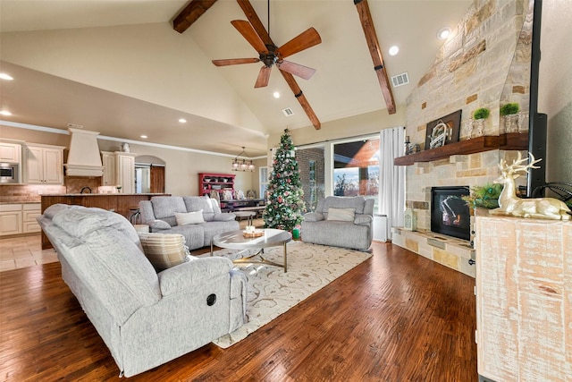 living room with beam ceiling, ceiling fan with notable chandelier, high vaulted ceiling, and dark hardwood / wood-style floors