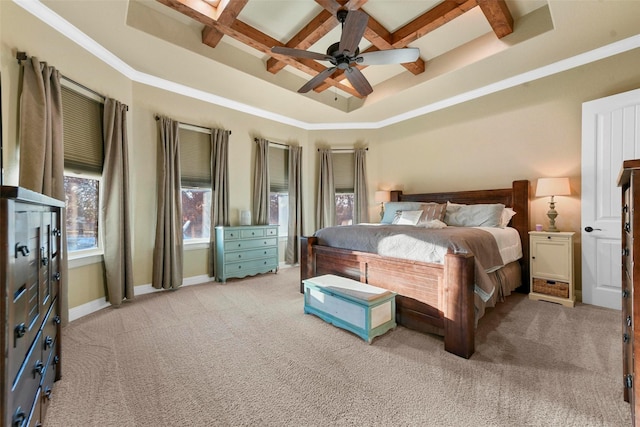 bedroom with coffered ceiling, light colored carpet, ceiling fan, crown molding, and beam ceiling