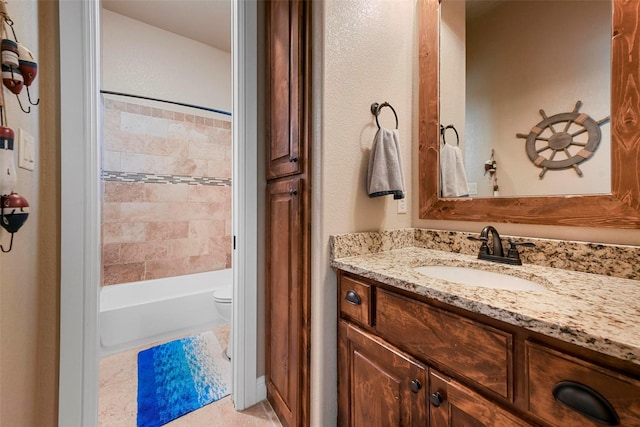 full bathroom featuring toilet, vanity, tile patterned floors, and tiled shower / bath combo