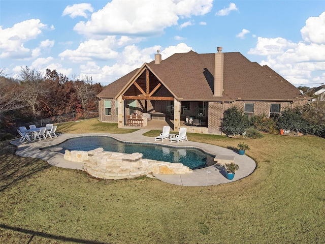 view of pool featuring a lawn and a patio