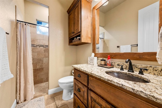 bathroom featuring vanity, toilet, and curtained shower