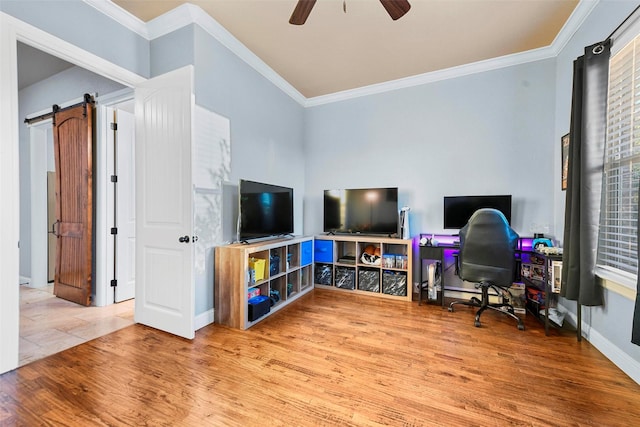 office area with a barn door, wood-type flooring, crown molding, and a wealth of natural light