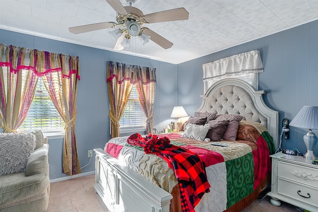 bedroom featuring multiple windows, ceiling fan, and carpet flooring