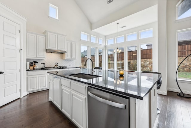 kitchen featuring white cabinetry, appliances with stainless steel finishes, sink, and a center island with sink