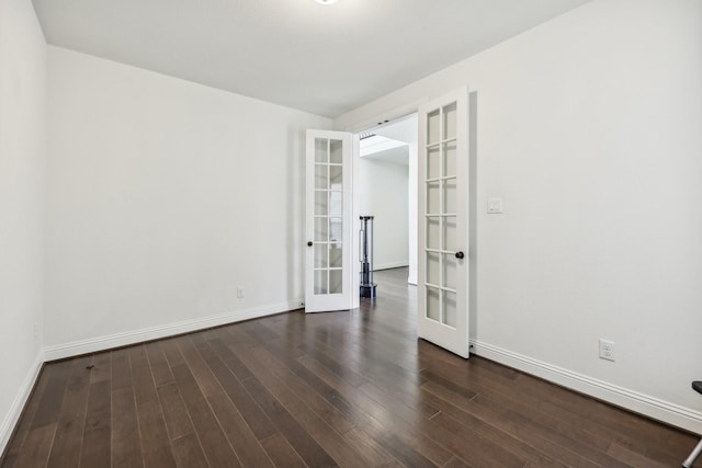 spare room featuring dark hardwood / wood-style flooring and french doors