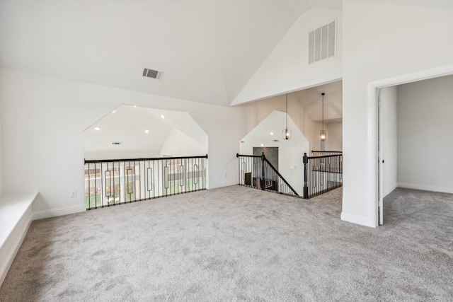 unfurnished room with high vaulted ceiling and carpet