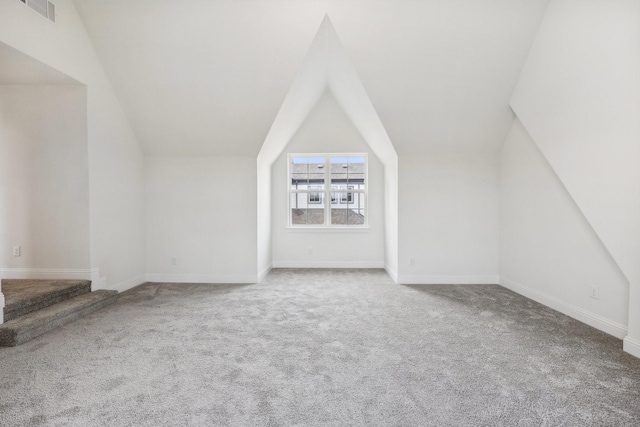 bonus room featuring lofted ceiling and carpet floors