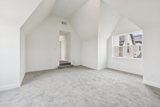 bonus room featuring light carpet and vaulted ceiling