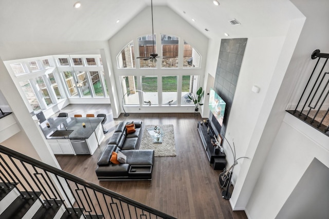 living room featuring ceiling fan, sink, dark hardwood / wood-style floors, and high vaulted ceiling