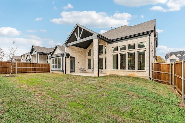 rear view of property with a patio area and a lawn