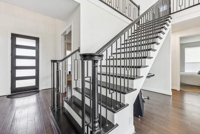 interior space with dark hardwood / wood-style floors and a high ceiling