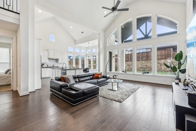 living room featuring plenty of natural light, dark wood-type flooring, high vaulted ceiling, and ceiling fan