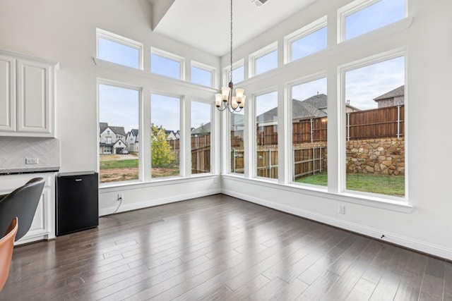 unfurnished sunroom with an inviting chandelier