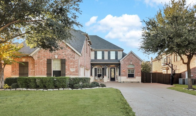 view of front of home with central AC and a front yard