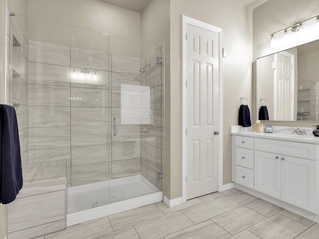 bathroom with vanity and a shower with shower door