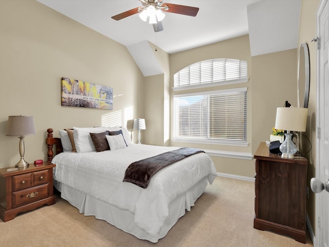 carpeted bedroom with vaulted ceiling and ceiling fan