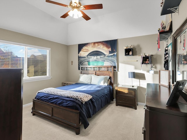 bedroom with lofted ceiling, light carpet, and ceiling fan