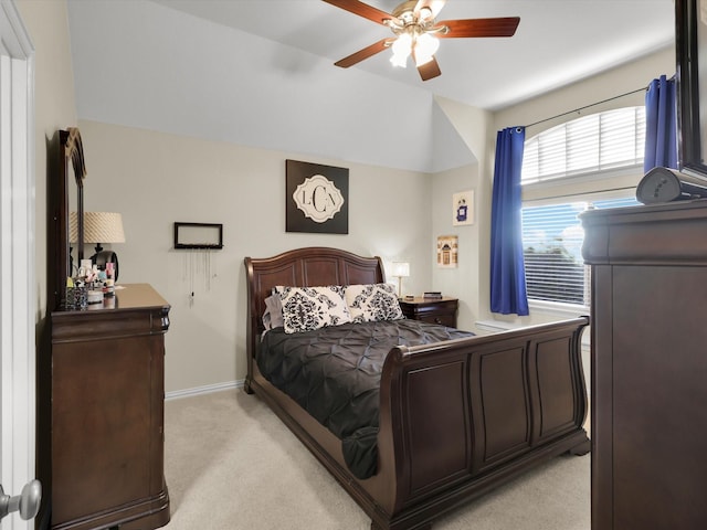 carpeted bedroom featuring vaulted ceiling and ceiling fan