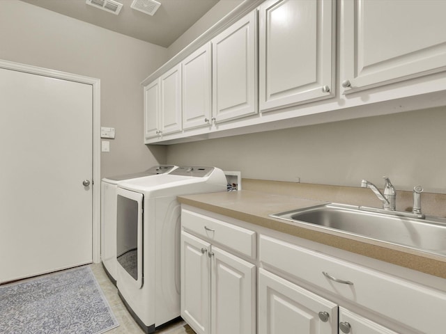 laundry area featuring cabinets, sink, light tile patterned floors, and independent washer and dryer