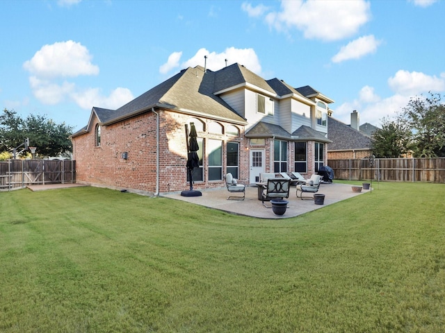 rear view of property featuring a patio area and a lawn