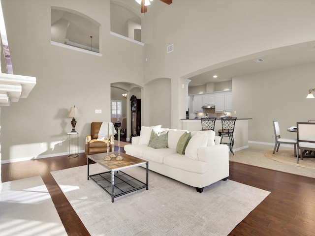 living room featuring ceiling fan and hardwood / wood-style floors