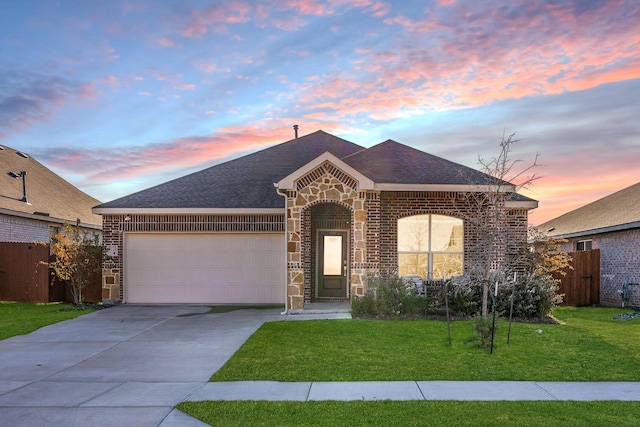 view of front of house featuring fence, an attached garage, concrete driveway, stone siding, and a lawn