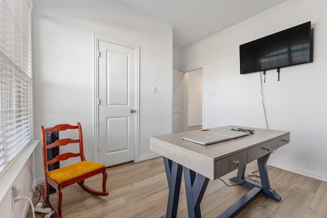 office featuring baseboards and light wood-style flooring