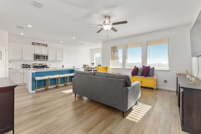 living room featuring recessed lighting, visible vents, light wood finished floors, and ceiling fan