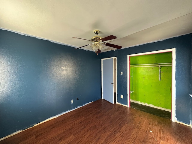 unfurnished bedroom featuring hardwood / wood-style flooring, ceiling fan, and a closet