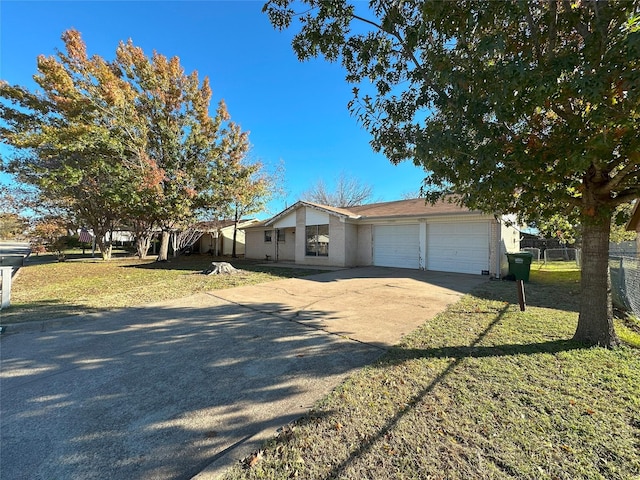 view of front of home with a front yard and a garage