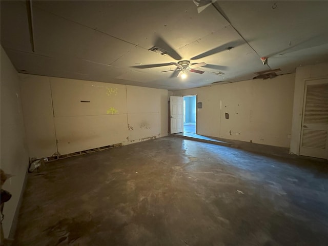 interior space featuring ceiling fan and concrete floors