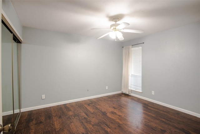 unfurnished bedroom featuring dark wood-type flooring, ceiling fan, and a closet