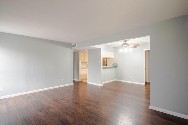 unfurnished living room with dark hardwood / wood-style flooring and ceiling fan