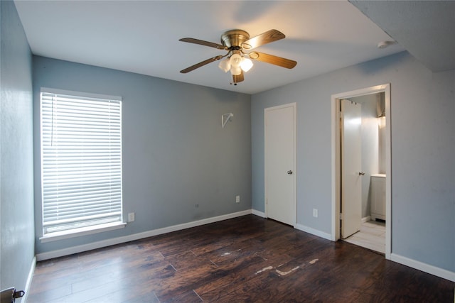 unfurnished bedroom with dark hardwood / wood-style flooring, ensuite bath, and ceiling fan