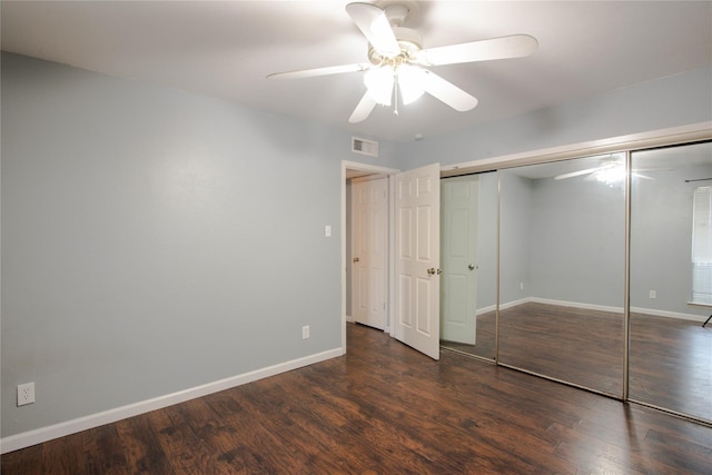 unfurnished bedroom with a closet, ceiling fan, and dark wood-type flooring