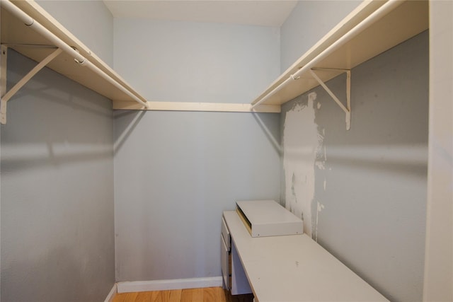 walk in closet featuring light hardwood / wood-style flooring