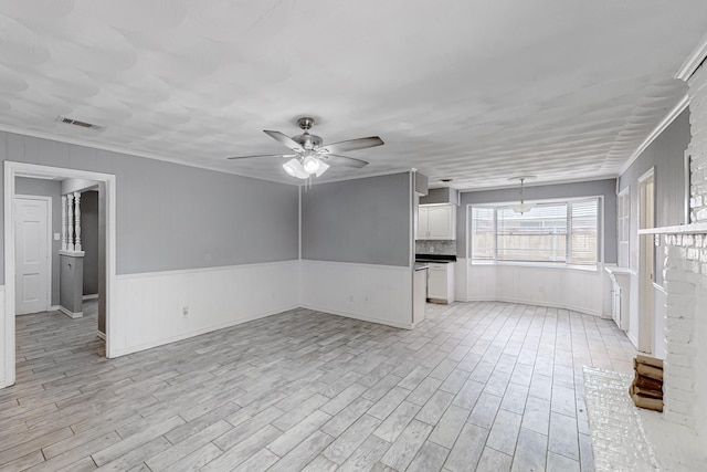 empty room with crown molding, ceiling fan, and light hardwood / wood-style flooring