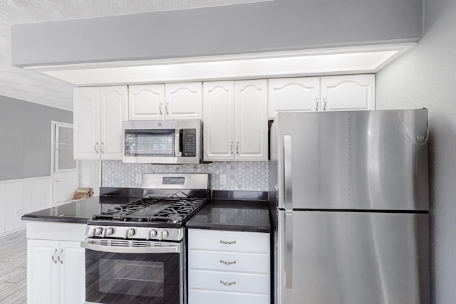 kitchen with tasteful backsplash, stainless steel appliances, and white cabinets