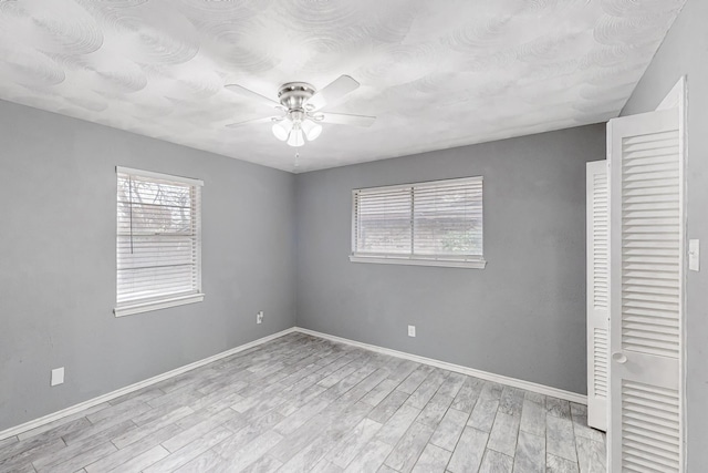 unfurnished room featuring ceiling fan and light wood-type flooring