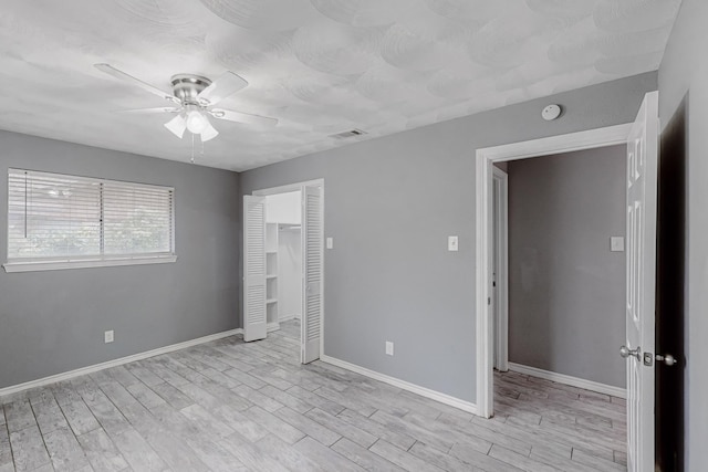 spare room featuring ceiling fan and light hardwood / wood-style floors