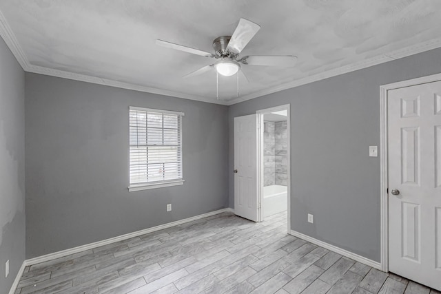 empty room featuring ceiling fan, ornamental molding, and light wood-type flooring