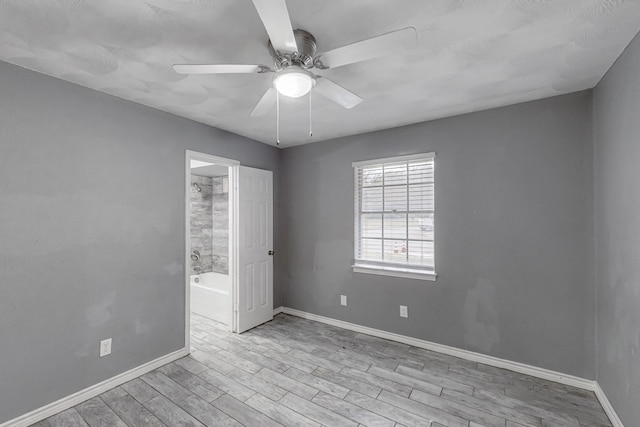 unfurnished room with ceiling fan and light wood-type flooring