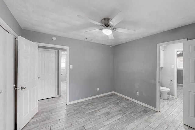 interior space featuring ensuite bathroom, ceiling fan, light hardwood / wood-style floors, and a closet