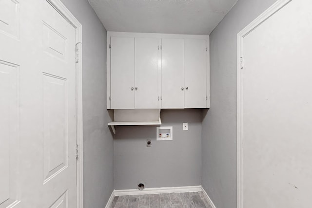 laundry area with cabinets, hookup for a washing machine, hardwood / wood-style floors, and electric dryer hookup