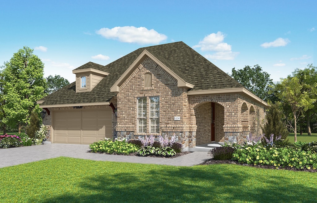 view of front of house with a garage and a front yard