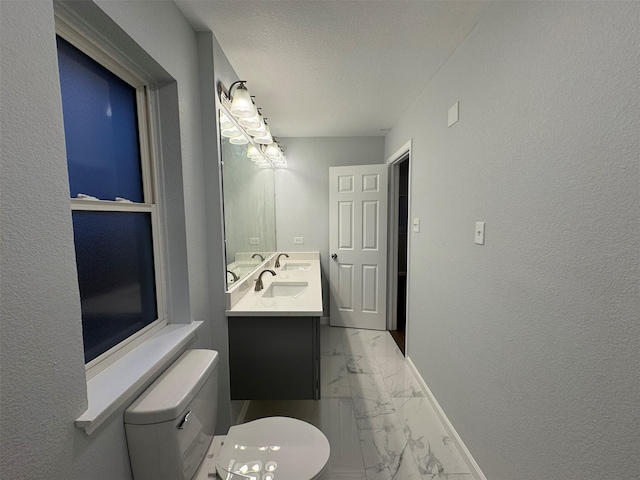 bathroom featuring vanity, a textured ceiling, and toilet