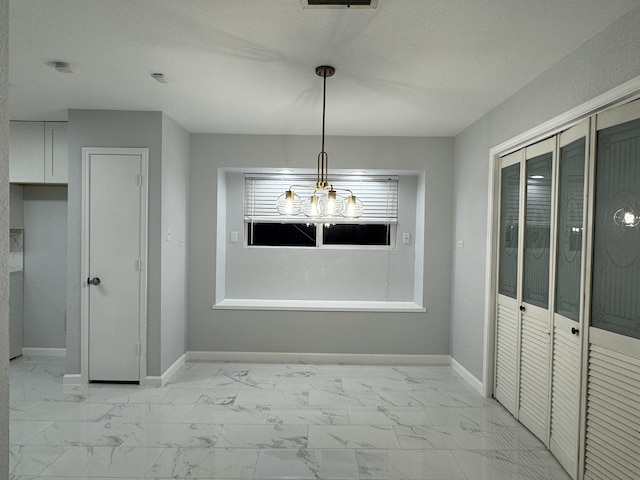 unfurnished dining area with a textured ceiling