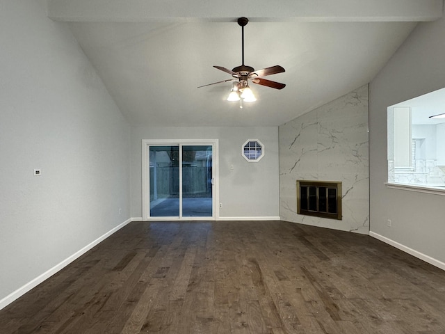 unfurnished living room featuring ceiling fan, dark hardwood / wood-style flooring, a premium fireplace, and vaulted ceiling